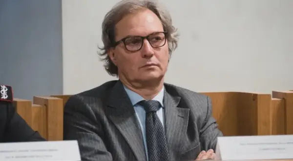Uomo con occhiali, abito gessato e cravatta scura. Un procuratore cosa fa? Si occupa di giustizia e indagini.