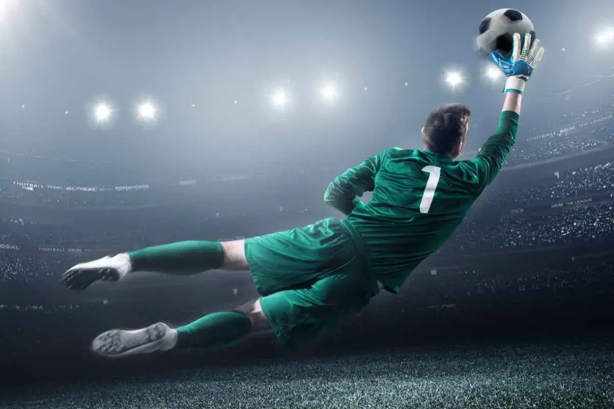 Portiere in tuffo aereo, con la palla in mano, numero 1 sulla maglia. Un'azione decisiva che vale più di uno stipendio portiere senza alloggio.